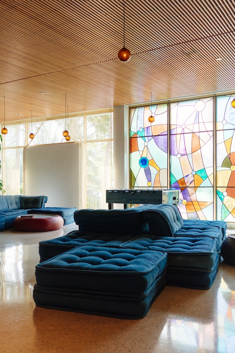 living room with blue sofa and colored windows