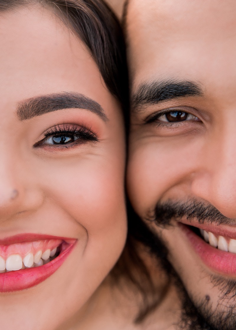 man and woman smiling next to each other