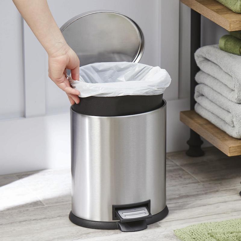metal trash can with white bag