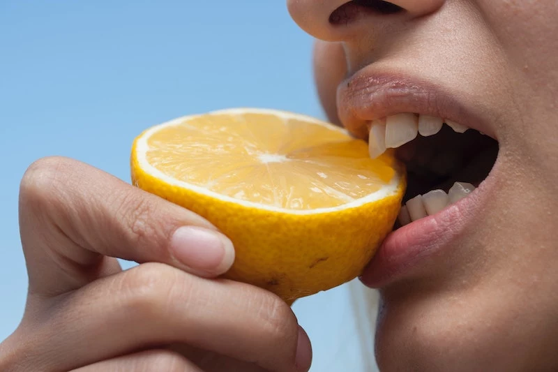 mouth eating a lemon