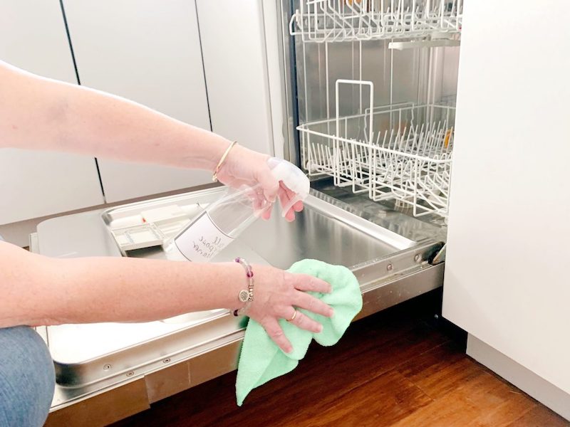 person cleaning the dishwasher