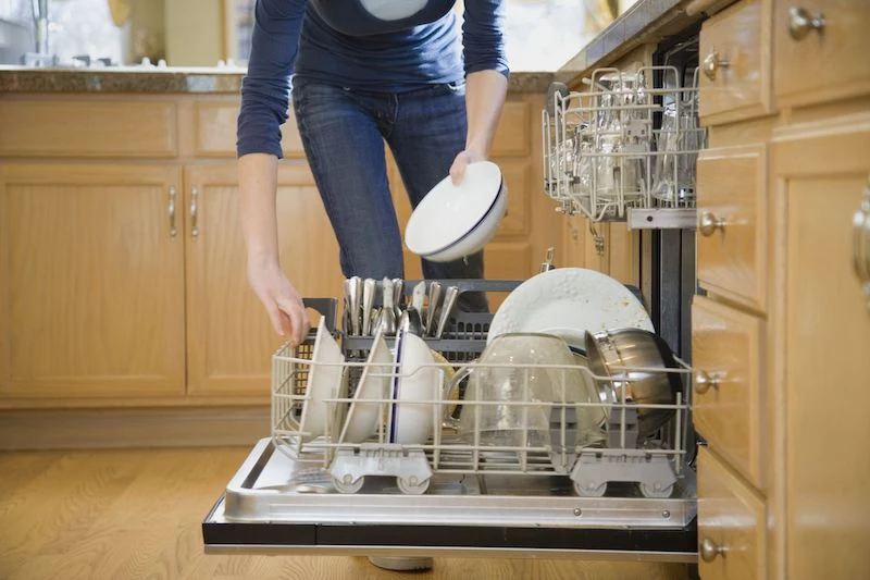 person unloading the dishwasher