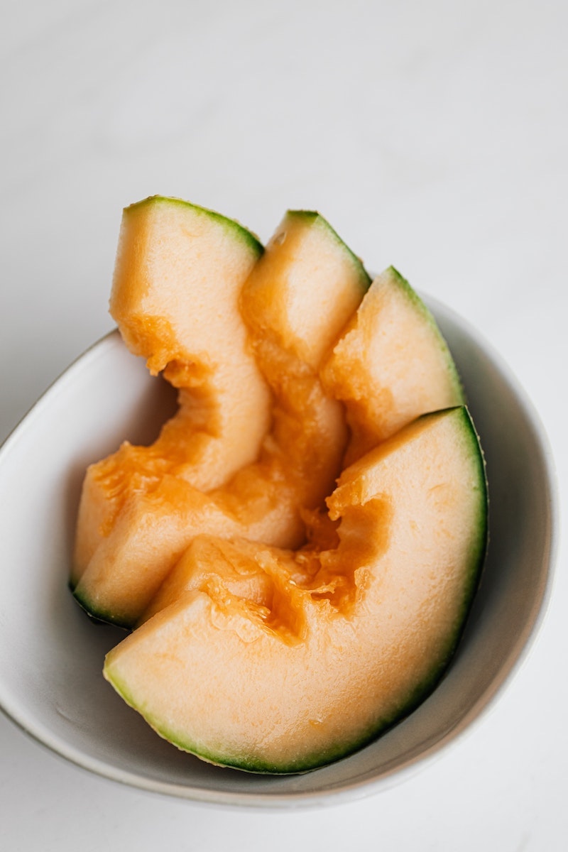 three cantaloup pieces in white bowl three cantaloup pieces in white bowl