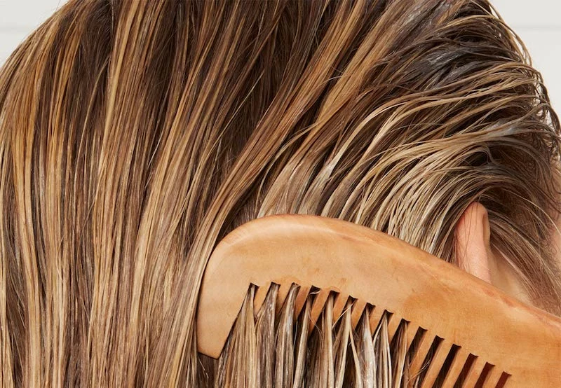 woman combing greasy blonde hair