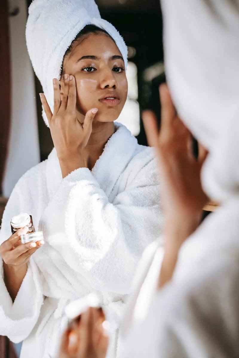 woman doing self care with towel on head