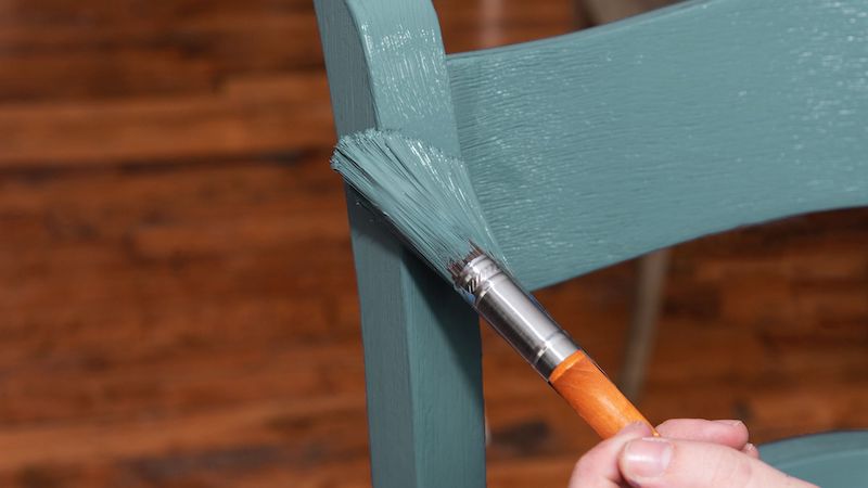 chair getting painted with green paint
