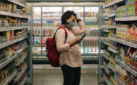 cut your grocery bill woman looking confused in supermarket isle