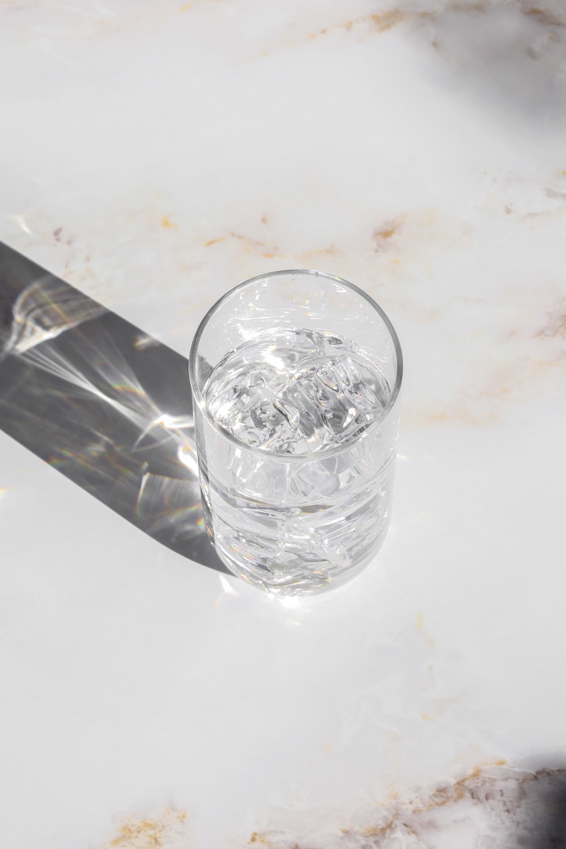 glass of water sitting on a marble counter