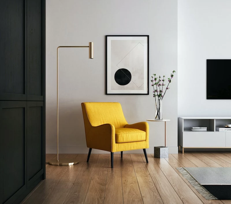interior design mistakes yellow chair with black and white art