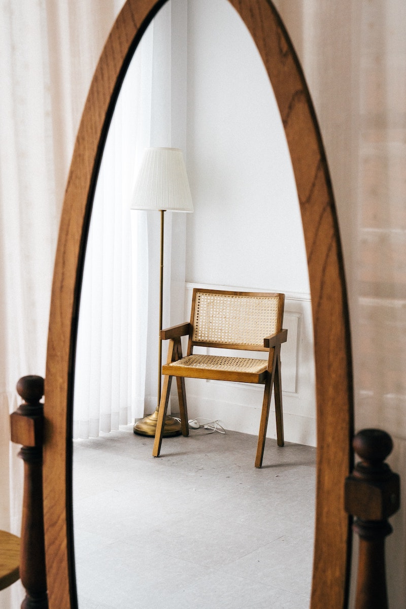 large mirror with chair in reflection