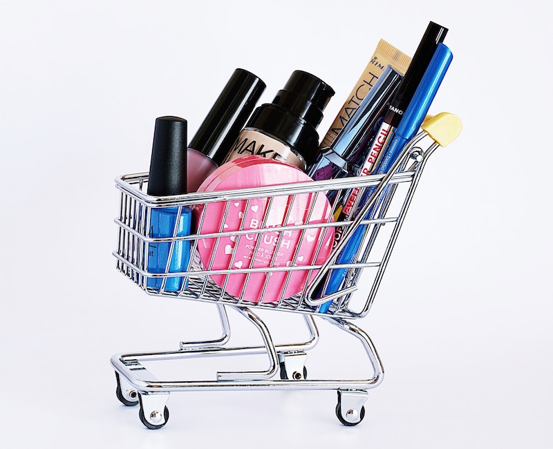 makeup products in a mini shopping cart