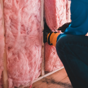 man installing insulation in home