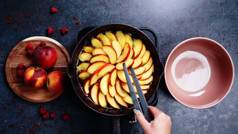 peach slices in a cast iron pan in a circle