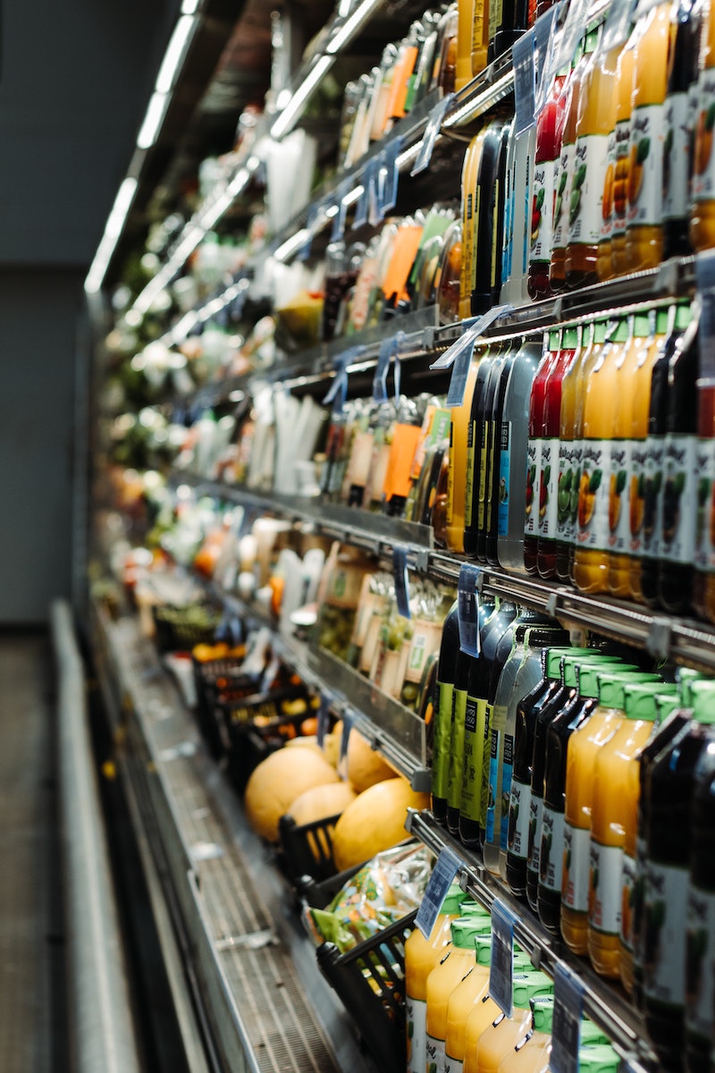 supermarket isle with juices and fruits
