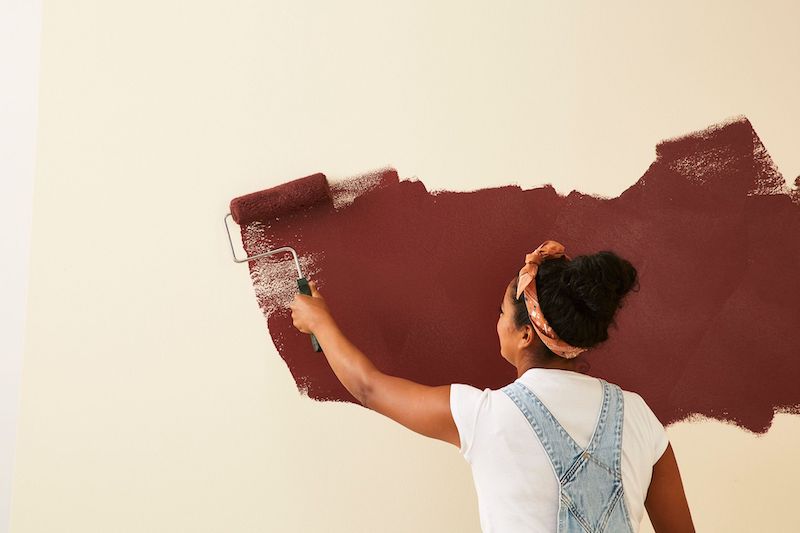 using roller to paint wall brown paint