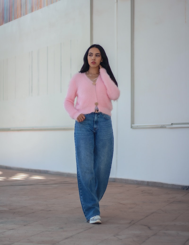 woman in jeans and pink fluffy sweater