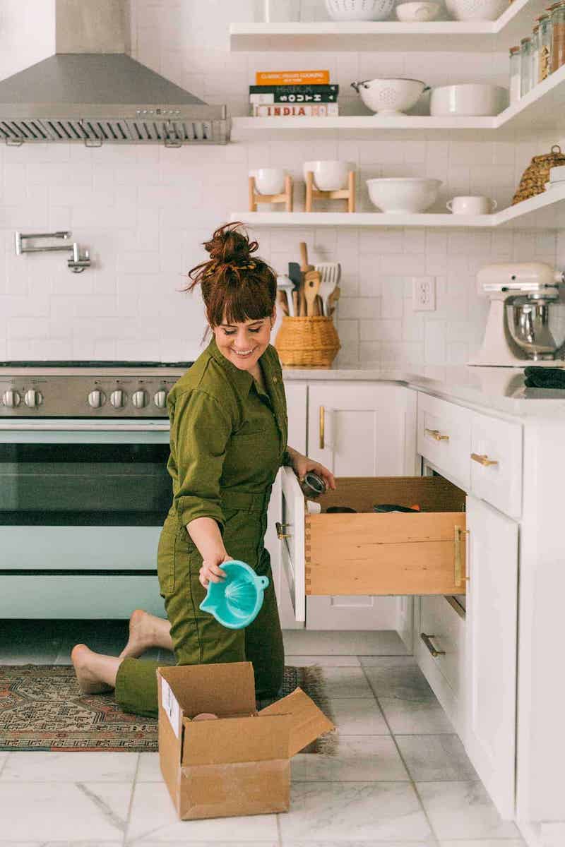 woman organizing her kitchen cabinets