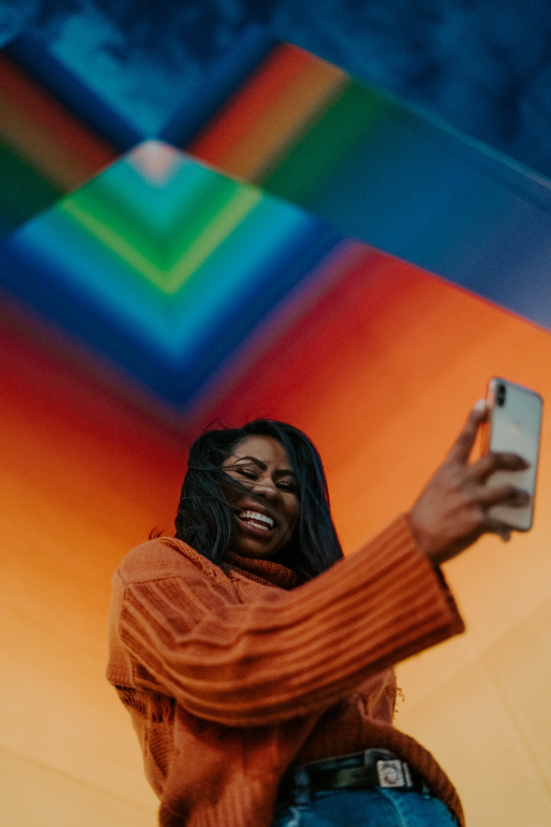 woman taking a slefie with her phone