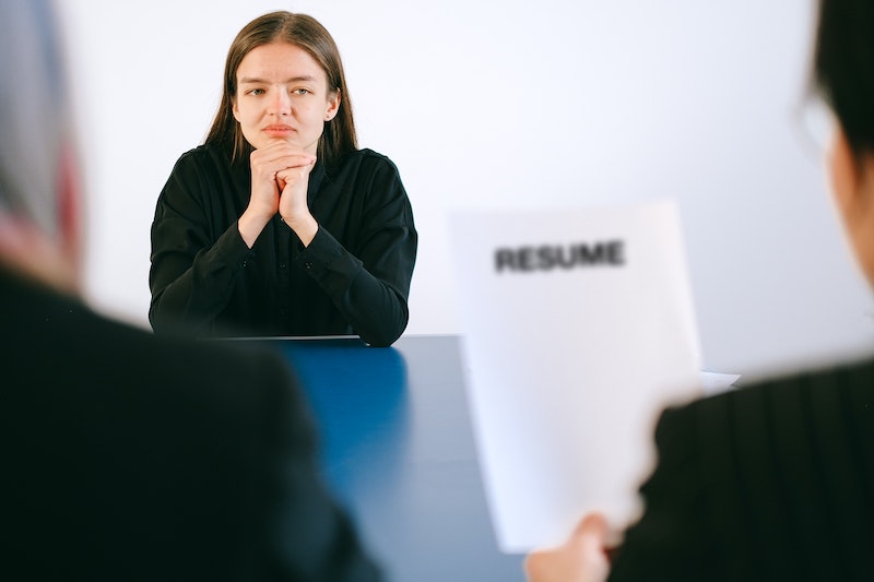 woman waiting while employers look at resume