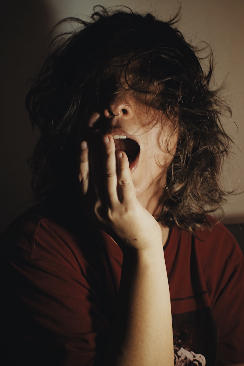 woman yawning with messy hair