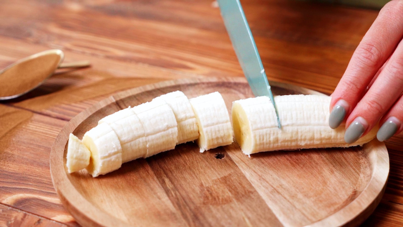 banana being chopped into small pieces