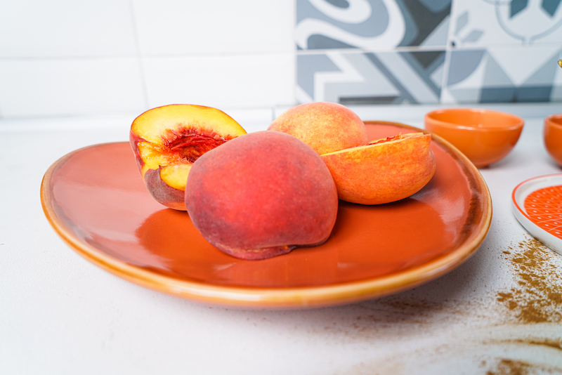 batch peaches cut in half on a plate