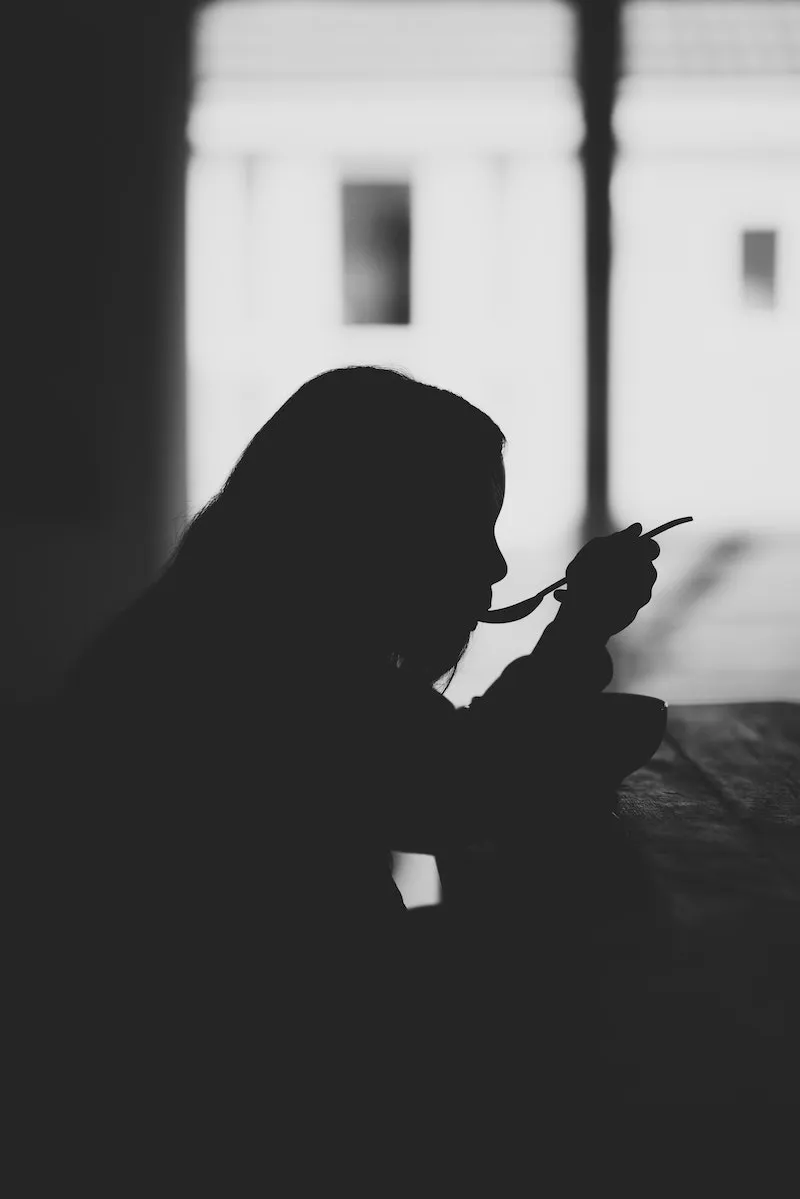 black and white photo of girl eating