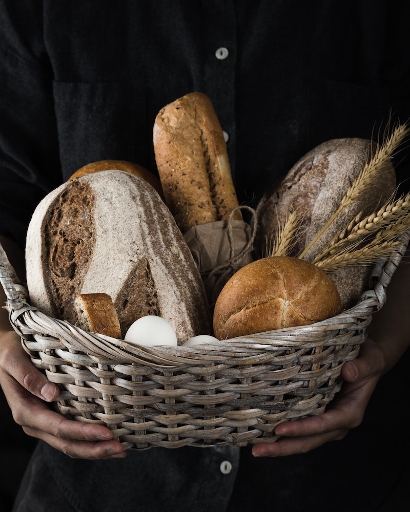 four different types of bread in a basket