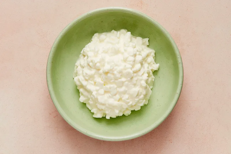 green bowl of cottage cheese
