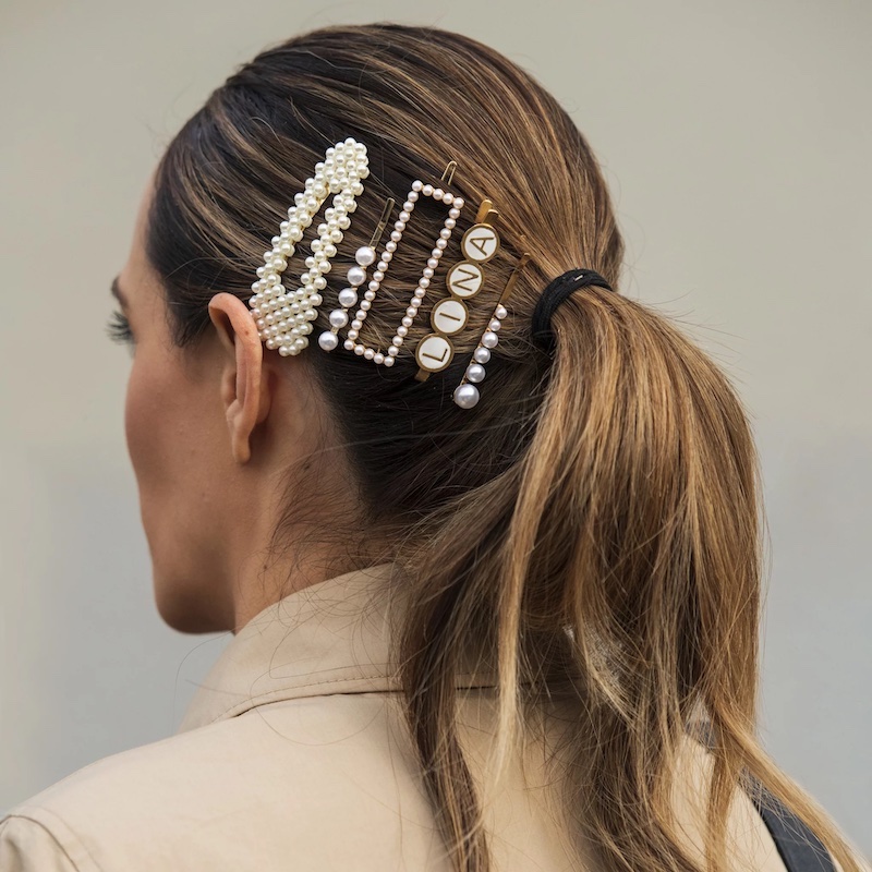 hair accessory trends woman with a ton of clips