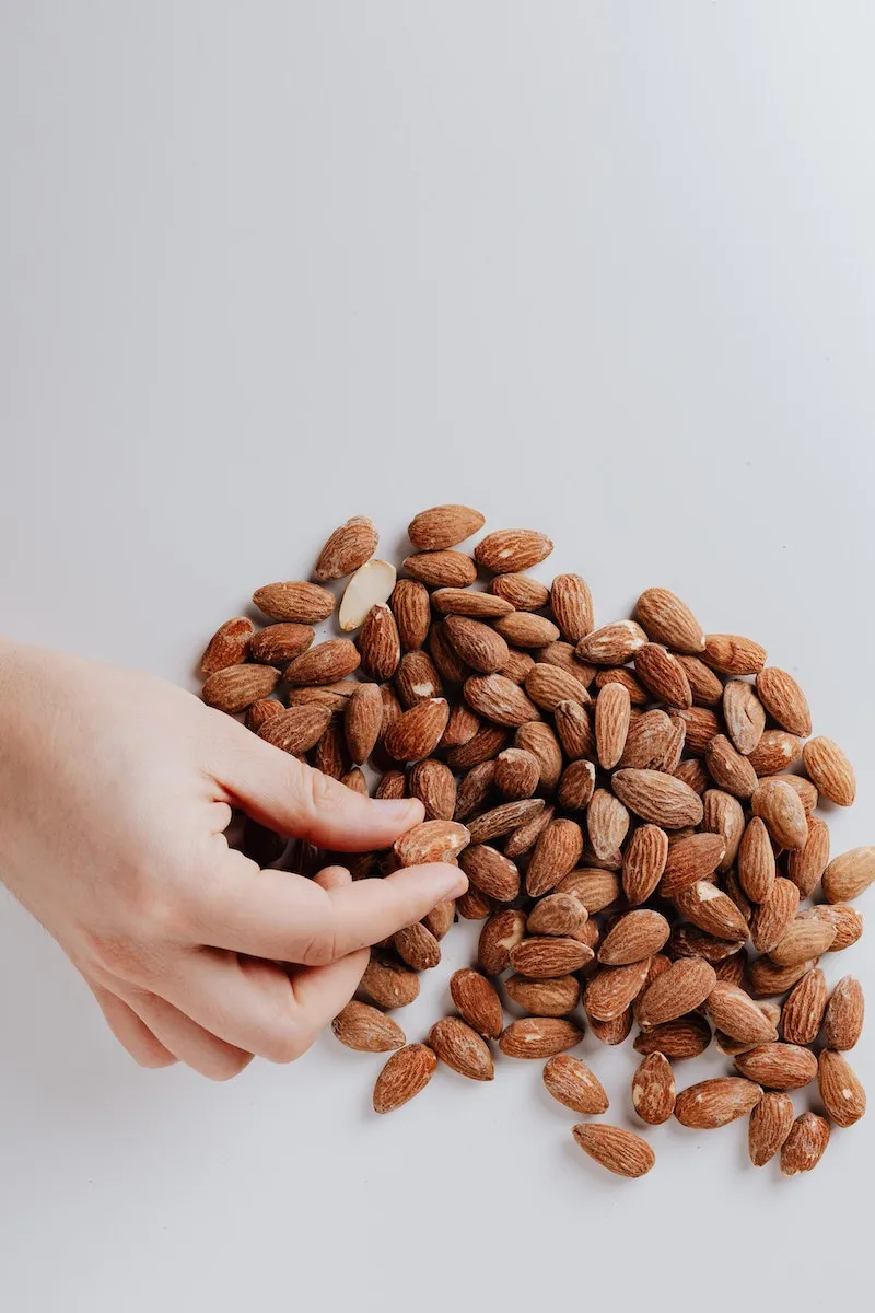 hand reaching for almonds