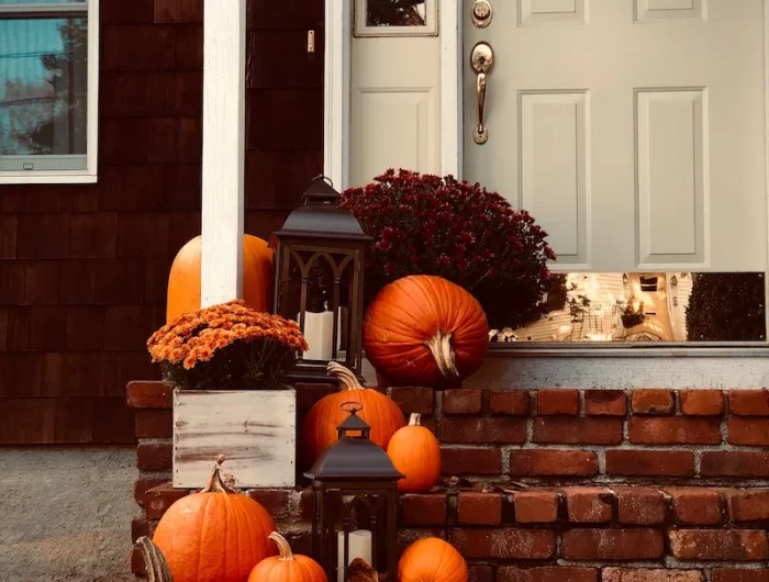 how to prepare your home for autumn front door with orange pumpkin decorations