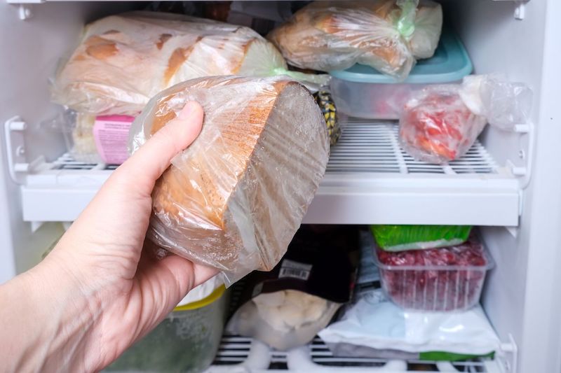 how to store bread hand putting bread in freezer