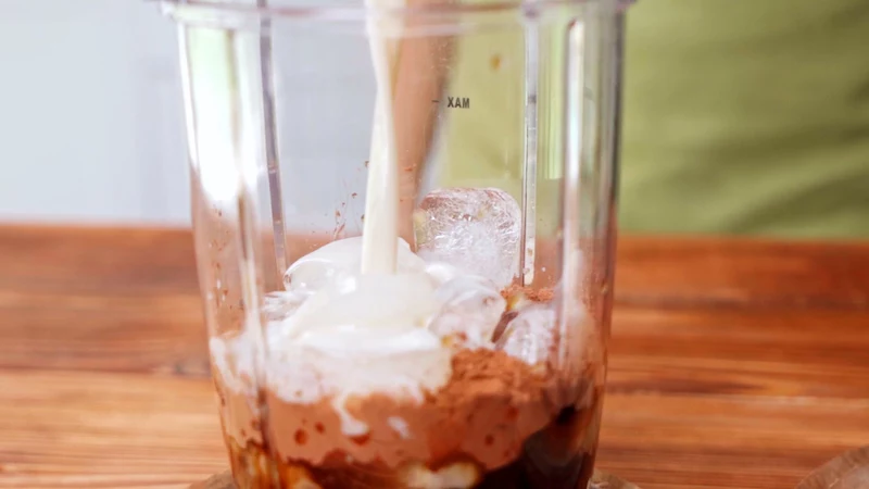 ice and milk in a blender with banana and coffee