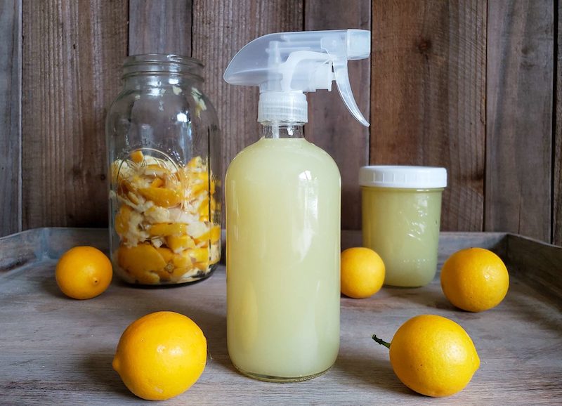 lemon spray in a bottle with lemons around