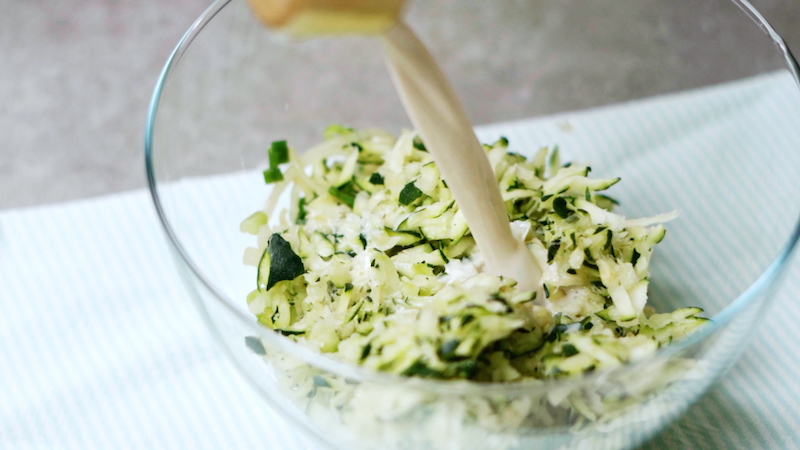 milk added to bowl of shredded zucchini milk added to bowl of shredded zucchini