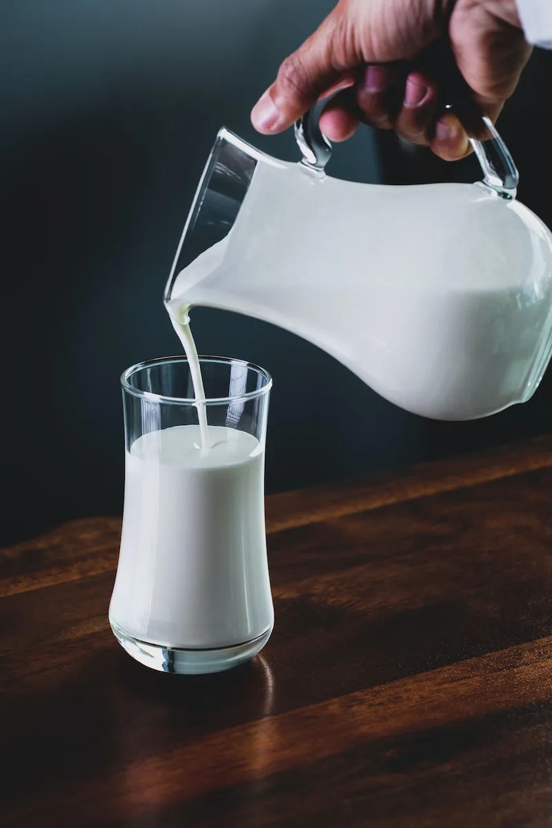 muscle building foods glass of milk getting poured in glass