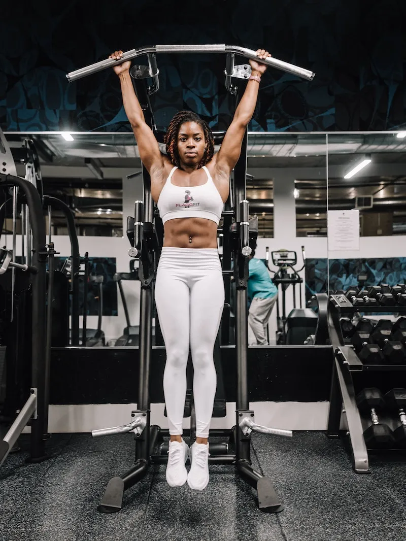 muscle building foods woman hanging by bars