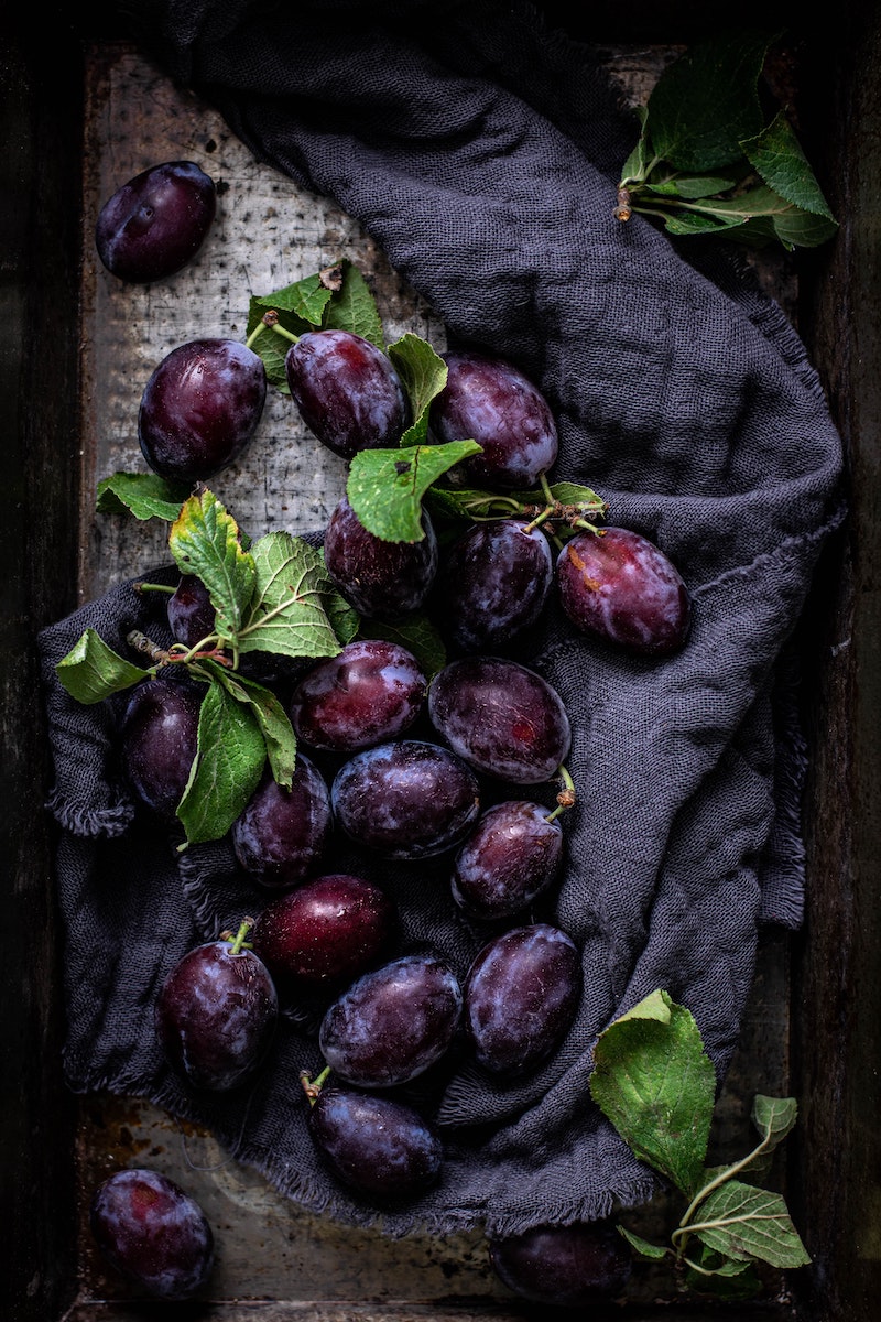purple plums on a towel