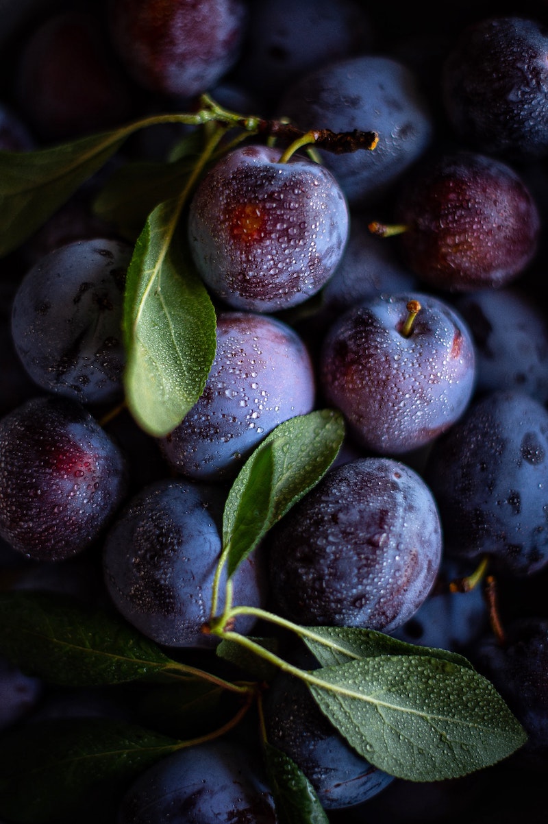 purple plums with moisture on them