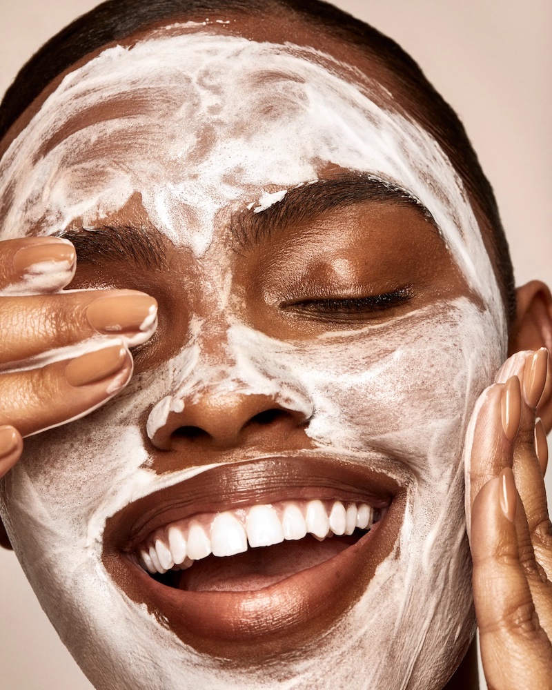 skin cycling woman with white cream on face