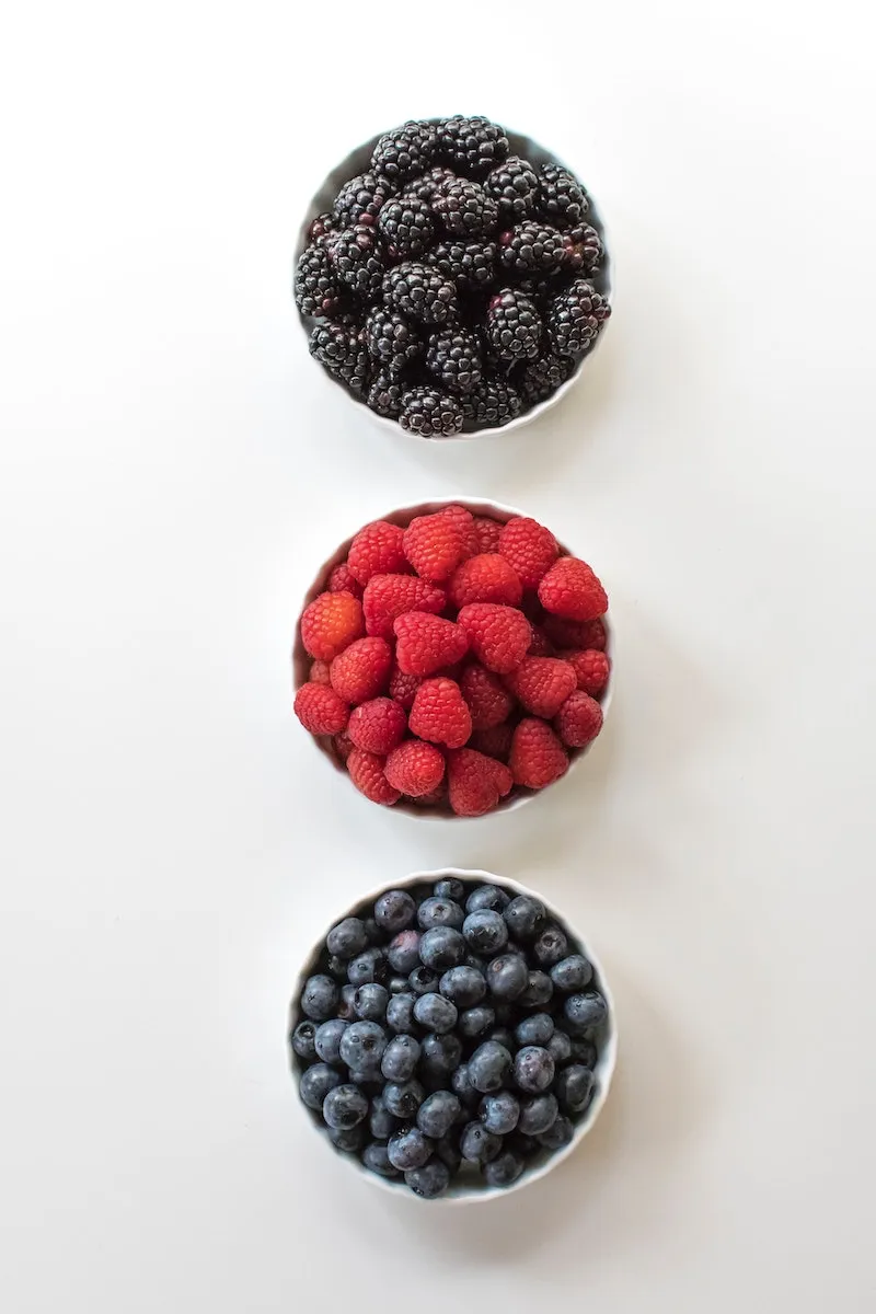 three types of berries blueberries raspberries