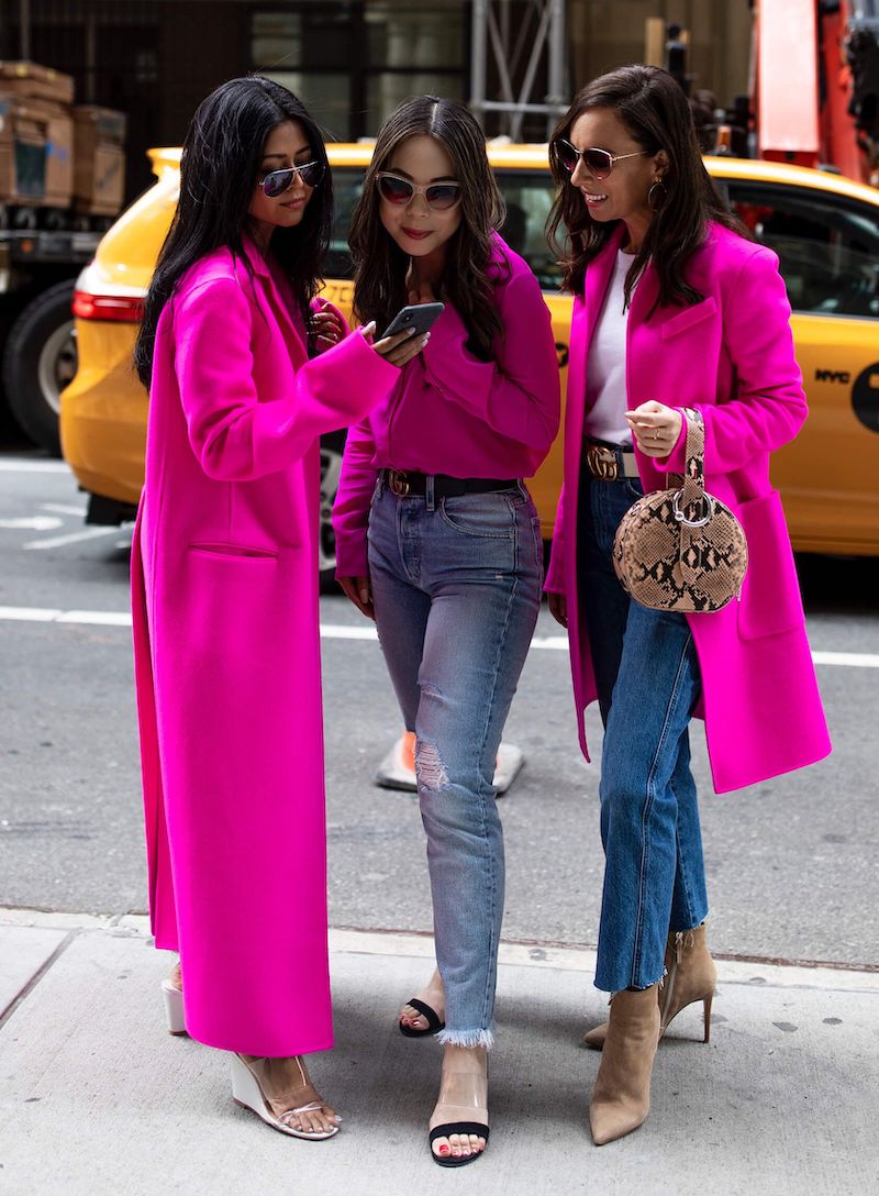 three women in hot pink blazers and tops