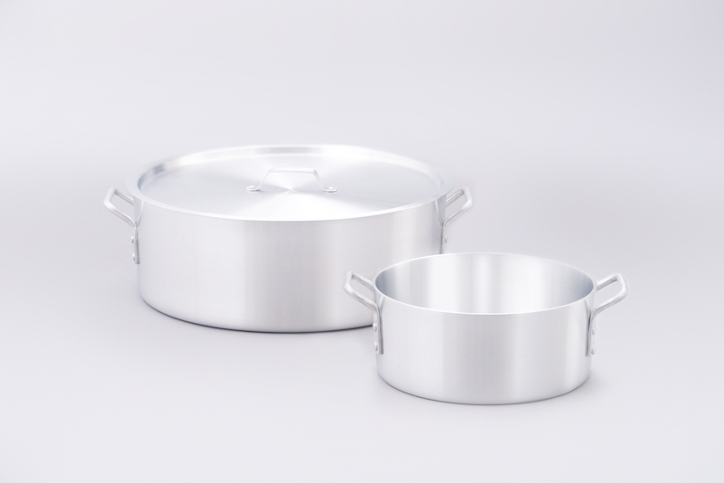 two aluminum pots on gray background