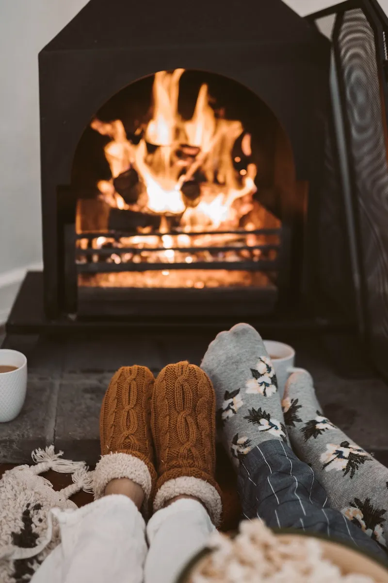two pairs of socks in front of fire place