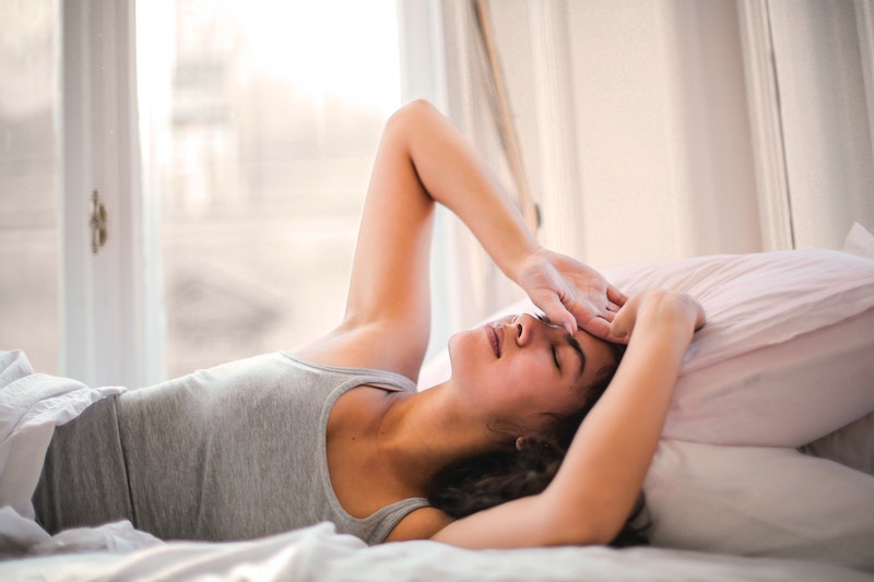 weak immune system person holding their head weak immune system person holding their head