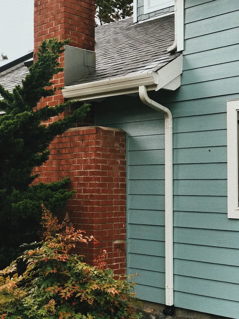 winterize your summer home blue house with white gutters