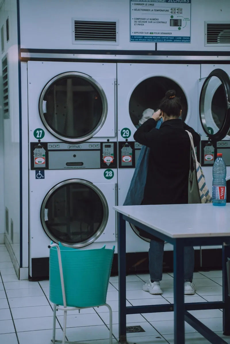 woman doing laundry at a laundry mat