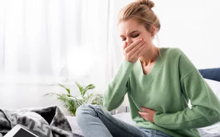 woman holding her mouth and stomach
