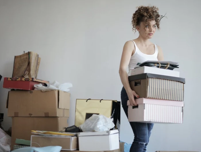 woman surrounded by boxes and things